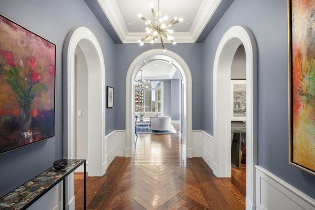 a view of a hallway with wooden floor and a dining room view