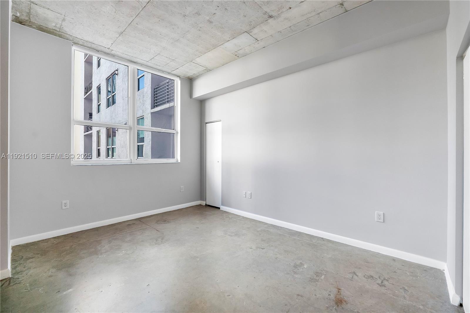 133 Northeast 2nd Avenue, Unit 508 Miami, FL 33132 - Photo 11 of 17 an empty room with windows