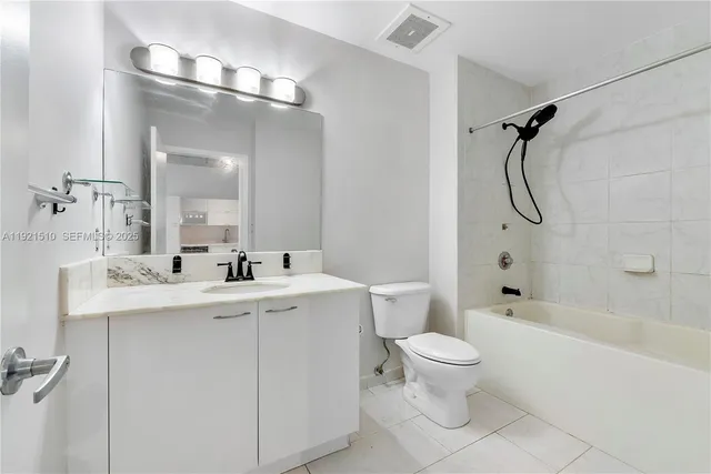 a bathroom with a sink toilet mirror and shower