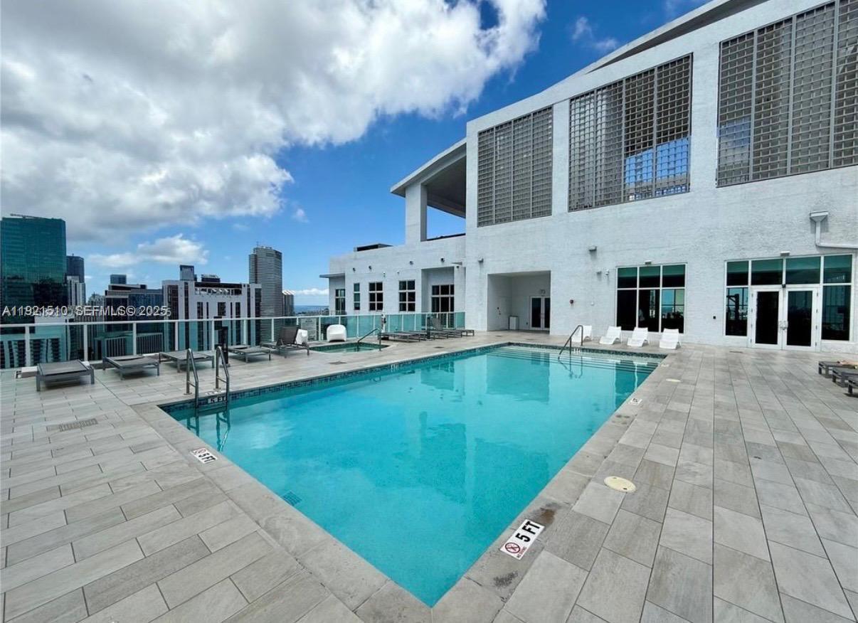 133 Northeast 2nd Avenue, Unit 508 Miami, FL 33132 - Photo 16 of 17 a view of swimming pool with a lounge chairs