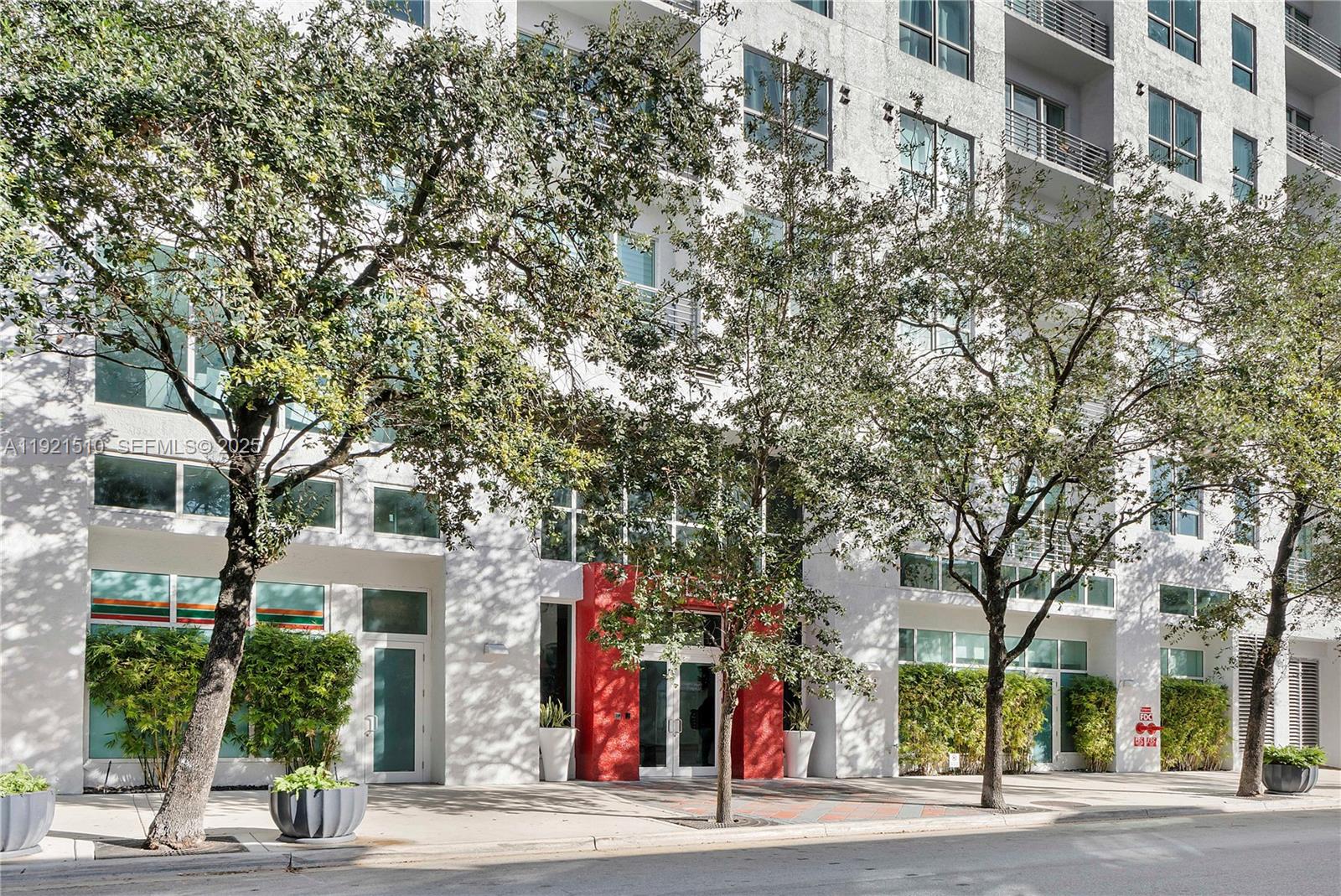 133 Northeast 2nd Avenue, Unit 508 Miami, FL 33132 - Photo 2 of 17 a view of a city street lined with buildings and trees