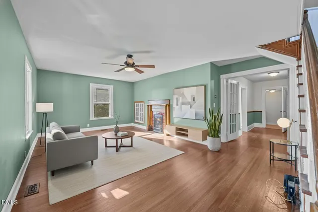 a living room with furniture and a potted plant
