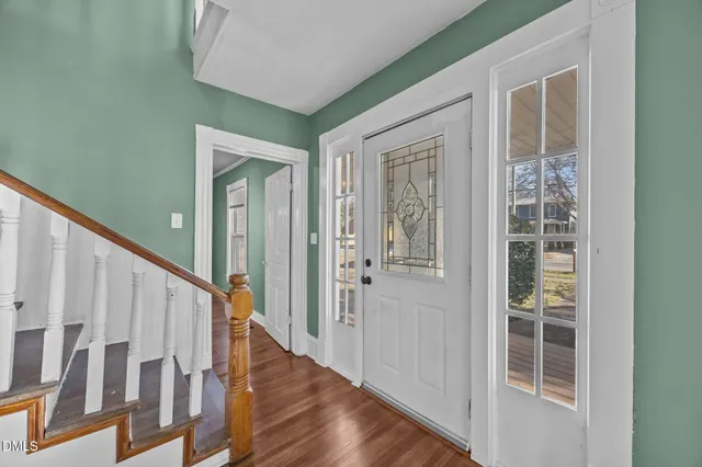 a view of an empty room with a window and fireplace