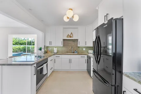 a kitchen with a refrigerator and a sink