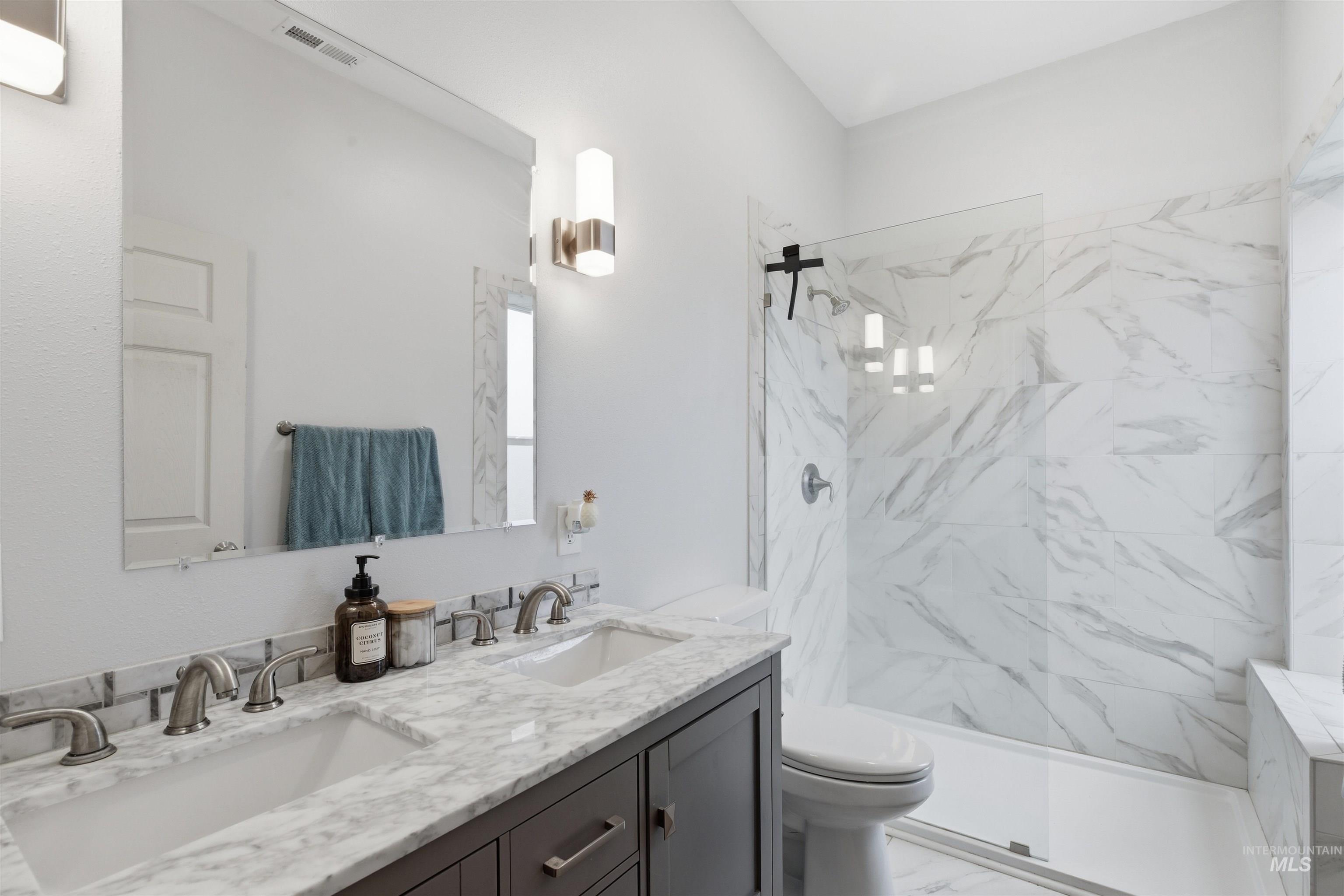 350 East Walnut Avenue Genesee, ID 83832 - Photo 10 of 27 Full bathroom featuring double vanity, a marble finish shower, and light marble finish flooring