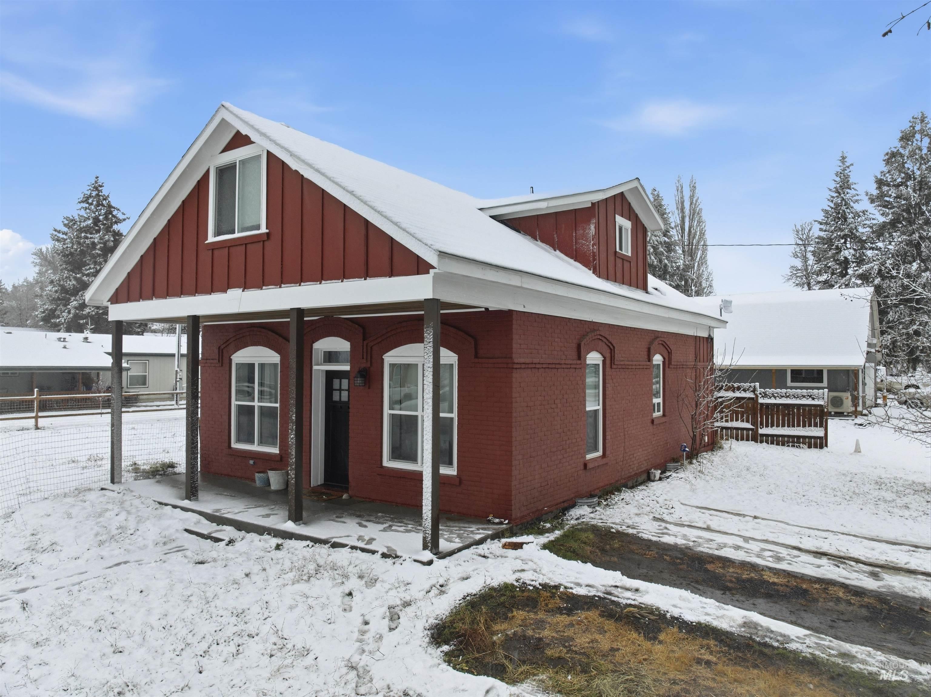 350 East Walnut Avenue Genesee, ID 83832 - Photo 18 of 27 View of front of house featuring a porch, board and batten siding, and brick siding