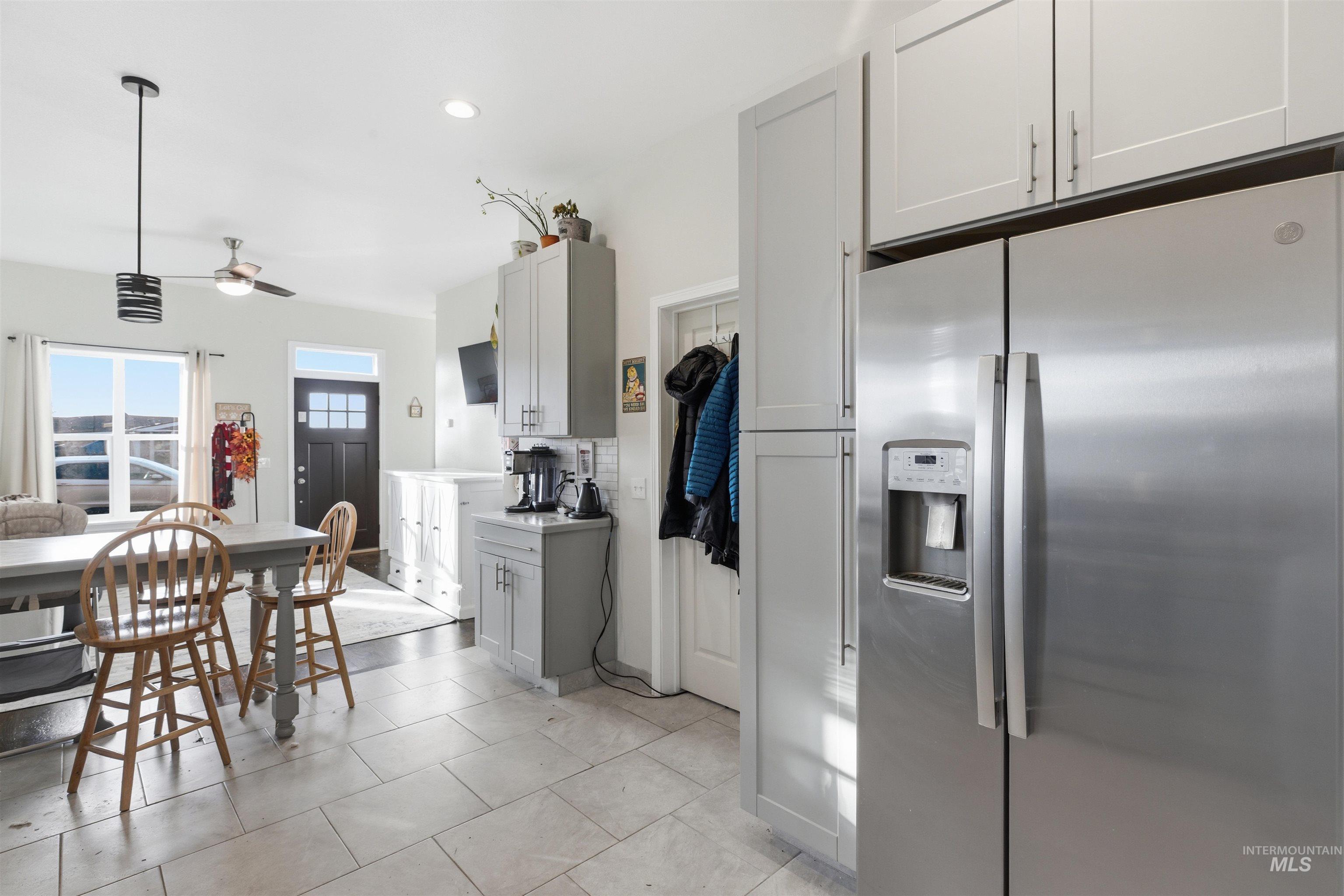 350 East Walnut Avenue Genesee, ID 83832 - Photo 6 of 27 Kitchen with stainless steel refrigerator with ice dispenser, light countertops, decorative light fixtures, ceiling fan, and recessed lighting