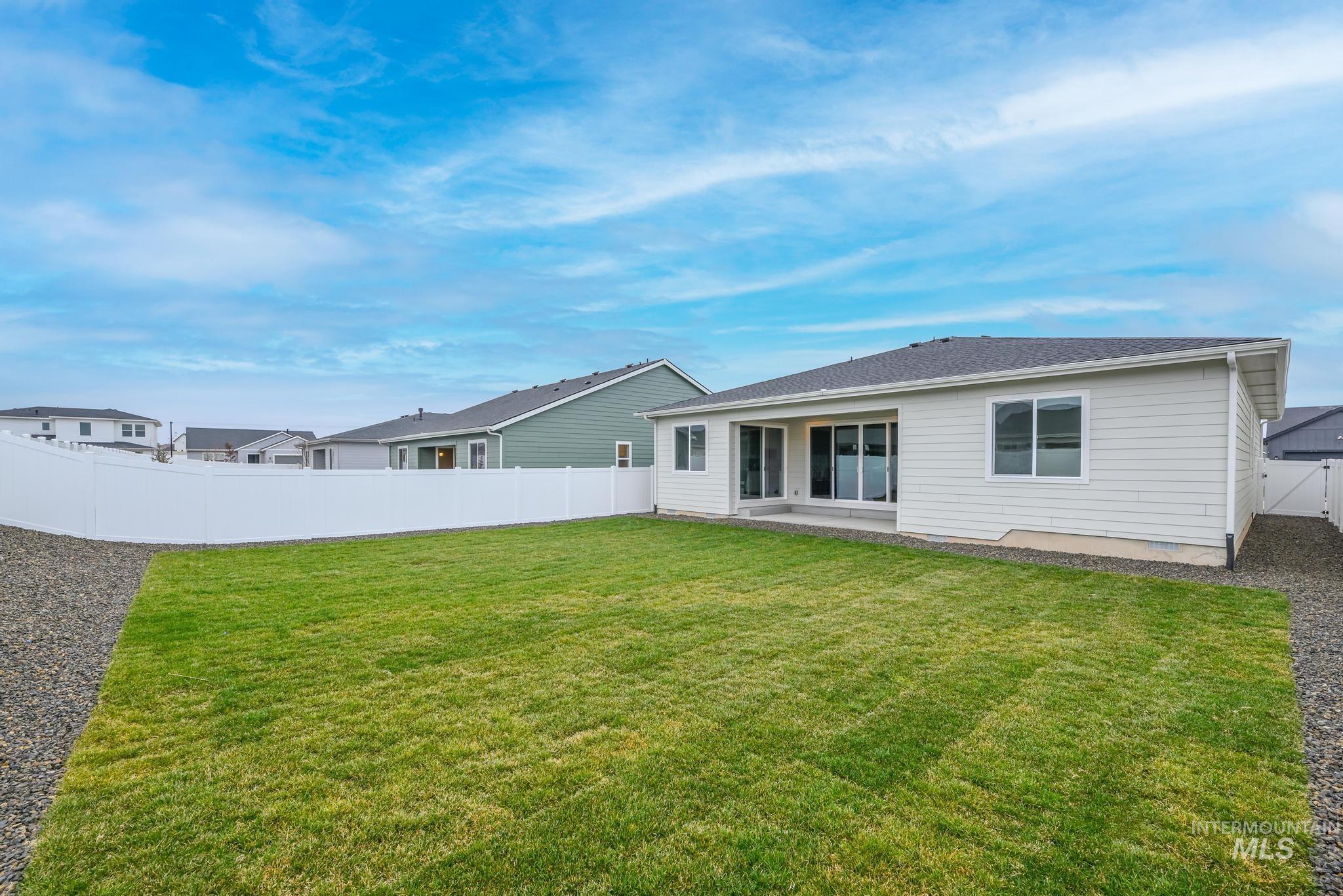 1761 West Arya Street Kuna, ID 83634 - Photo 12 of 12 Rear view of house featuring a patio and a fenced backyard