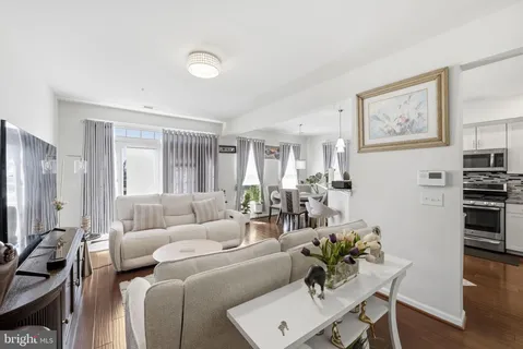 a living room with furniture kitchen and a window