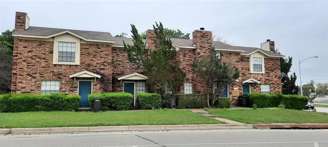 a front view of a house with a yard and a garage