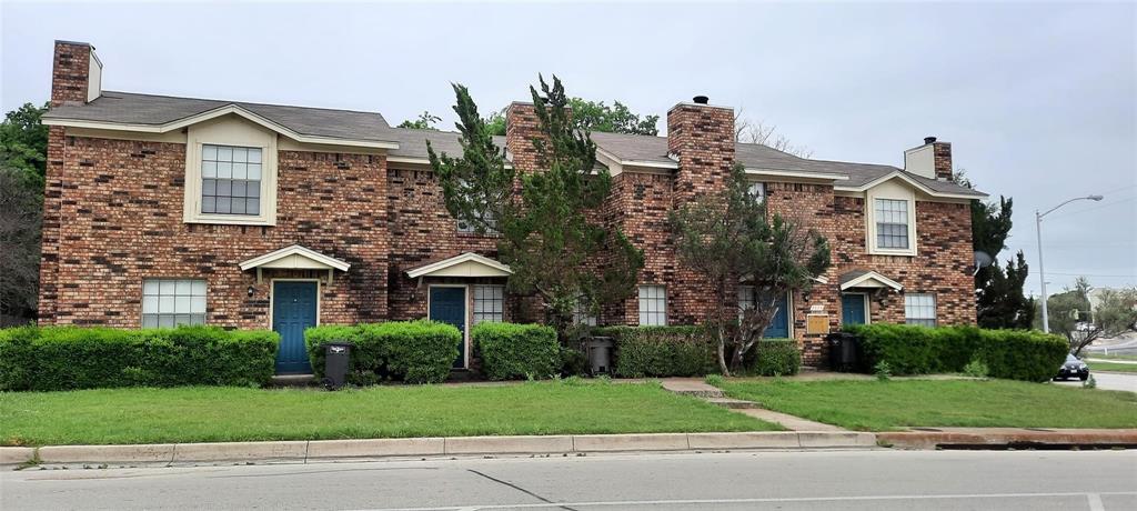a front view of a house with a yard and a garage