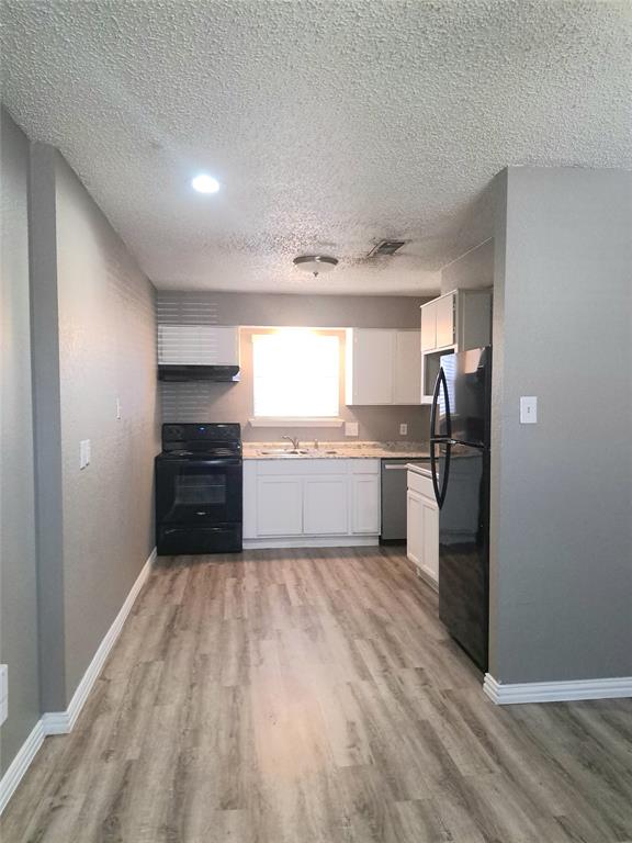 3225 Cortez Drive Fort Worth, TX 76116 - Photo 6 of 12 a kitchen with granite countertop a refrigerator and a sink