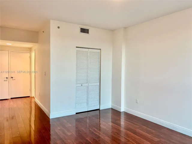 an empty room with wooden floor