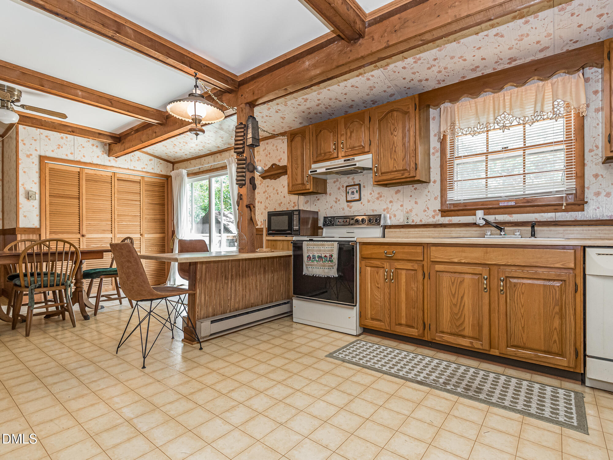 381 Royal Road Roseboro, NC 28382 - Photo 11 of 30 a kitchen with stainless steel appliances granite countertop a stove a sink dishwasher and cabinets with wooden floor