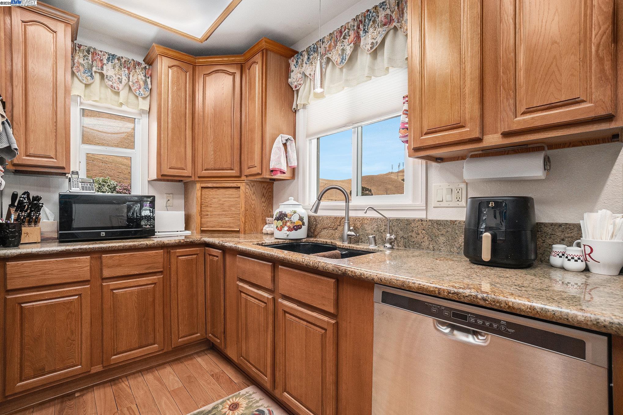 5799 Nortonville Road Pittsburg, CA 94565 - Photo 21 of 59 a kitchen with granite countertop stainless steel appliances a sink window and cabinets