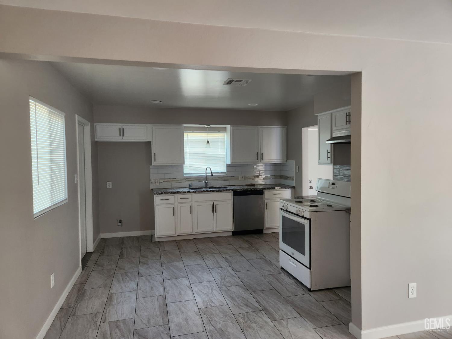 Undisclosed Address Bakersfield, CA 93309 - Photo 6 of 22 a kitchen with stainless steel appliances granite countertop a stove a sink and a refrigerator