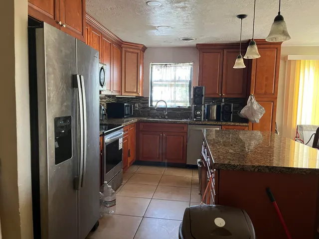 a view of a livingroom with a ceiling fan and window