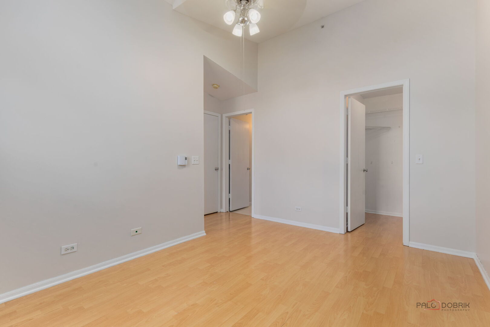 1506 Spring Brook Court, Unit 2C Round Lake Beach, IL 60073 - Photo 11 of 16 a view of an empty room with a chandelier fan