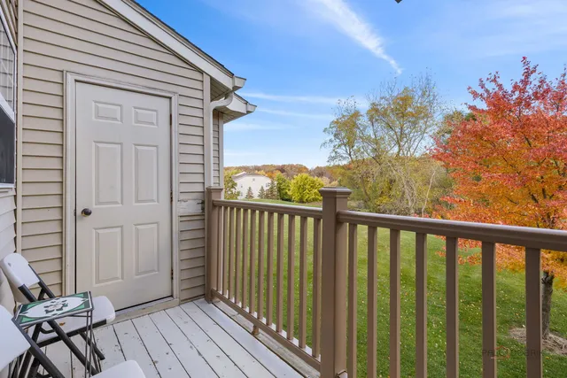 a view of a balcony with wooden floor and fence