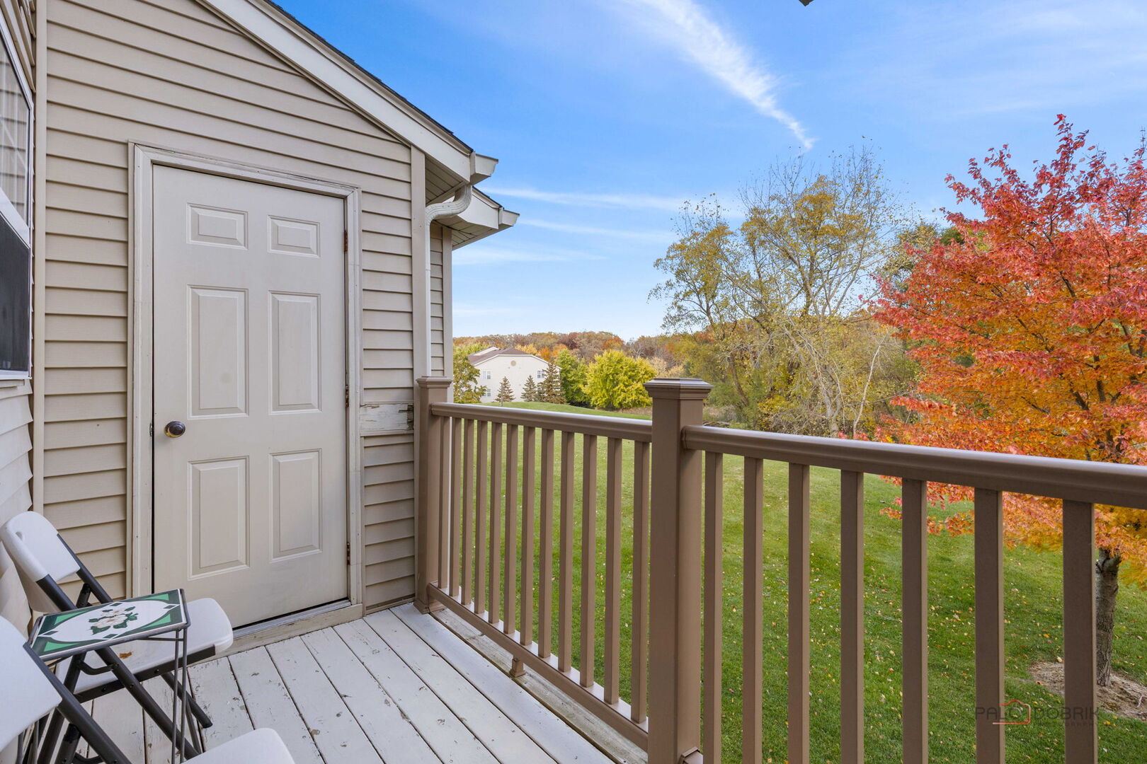 1506 Spring Brook Court, Unit 2C Round Lake Beach, IL 60073 - Photo 15 of 16 a view of a balcony with wooden floor and fence