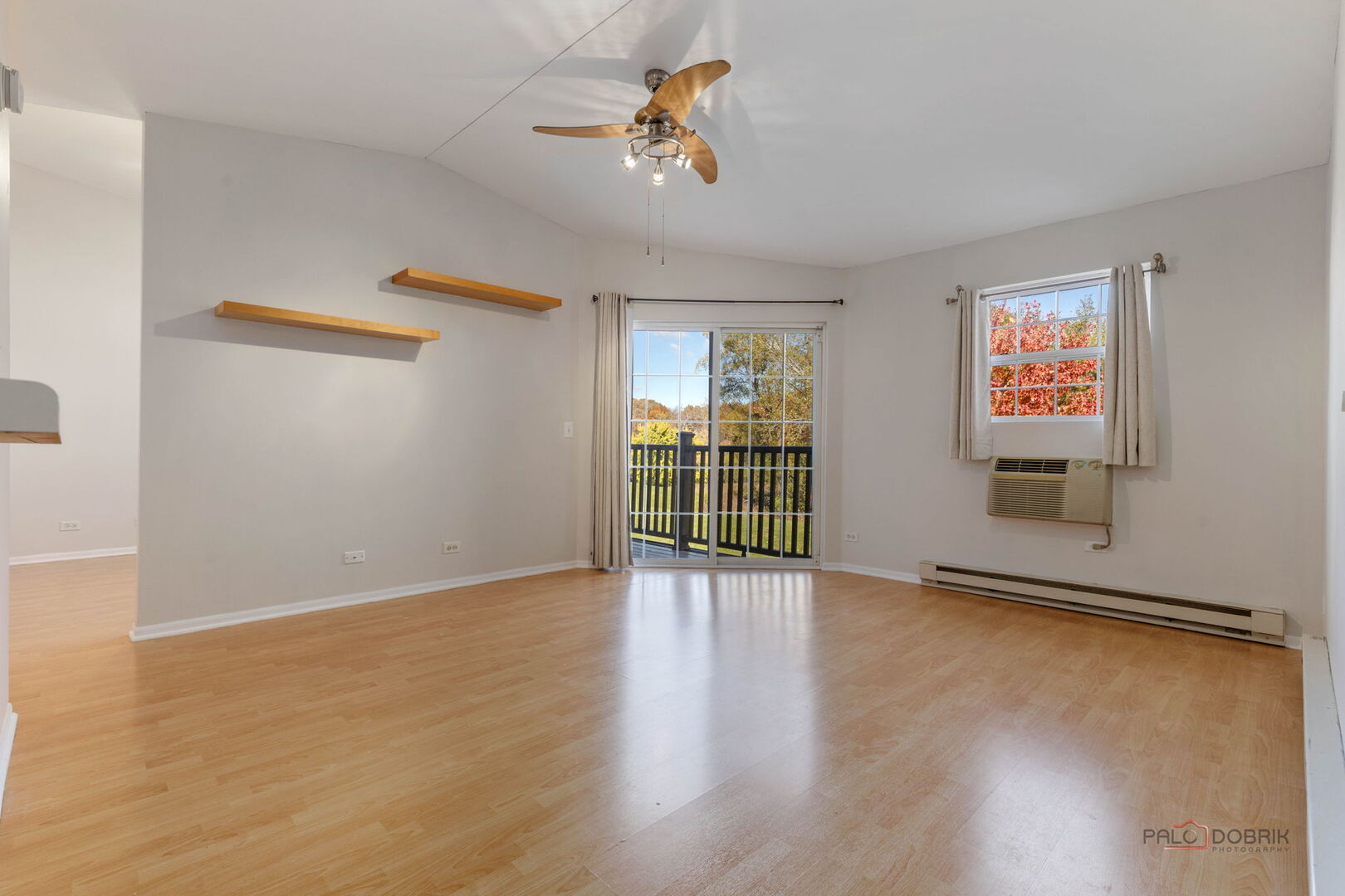 1506 Spring Brook Court, Unit 2C Round Lake Beach, IL 60073 - Photo 3 of 16 wooden floor in an empty room with a window