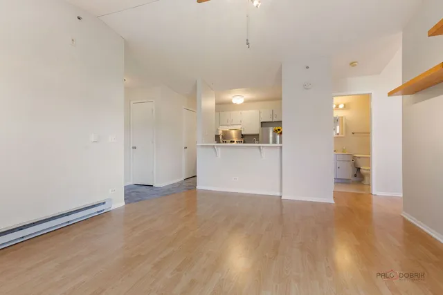 a view of a kitchen with a sink and a refrigerator