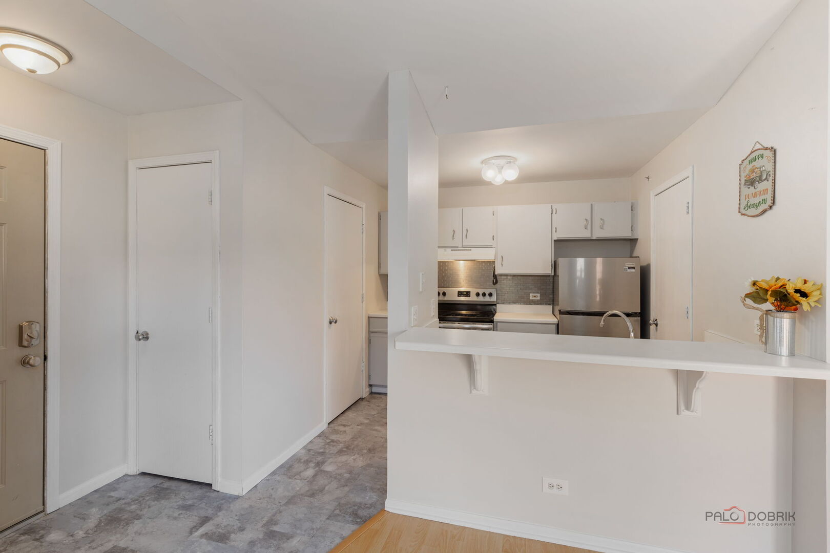 1506 Spring Brook Court, Unit 2C Round Lake Beach, IL 60073 - Photo 6 of 16 a kitchen with stainless steel appliances a refrigerator sink stove and microwave