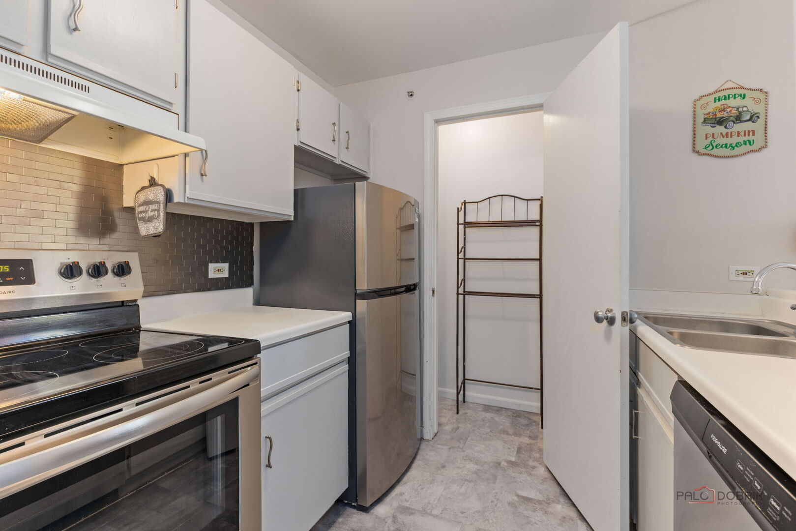 1506 Spring Brook Court, Unit 2C Round Lake Beach, IL 60073 - Photo 9 of 16 a kitchen with a refrigerator and a sink
