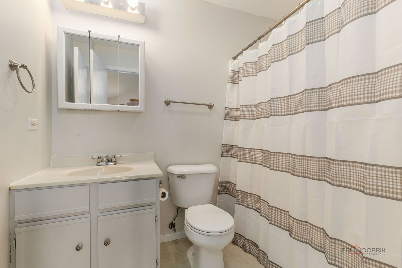 1506 Spring Brook Court, Unit 2C Round Lake Beach, IL 60073 - Photo 10 of 16 a bathroom with a sink toilet and vanity