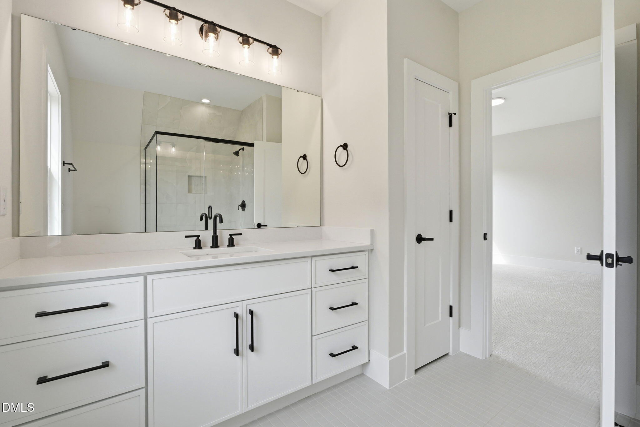 1304 Sanctuary Pond Drive Raleigh, NC 27606 - Photo 37 of 52 a bathroom with a double vanity sink and mirror
