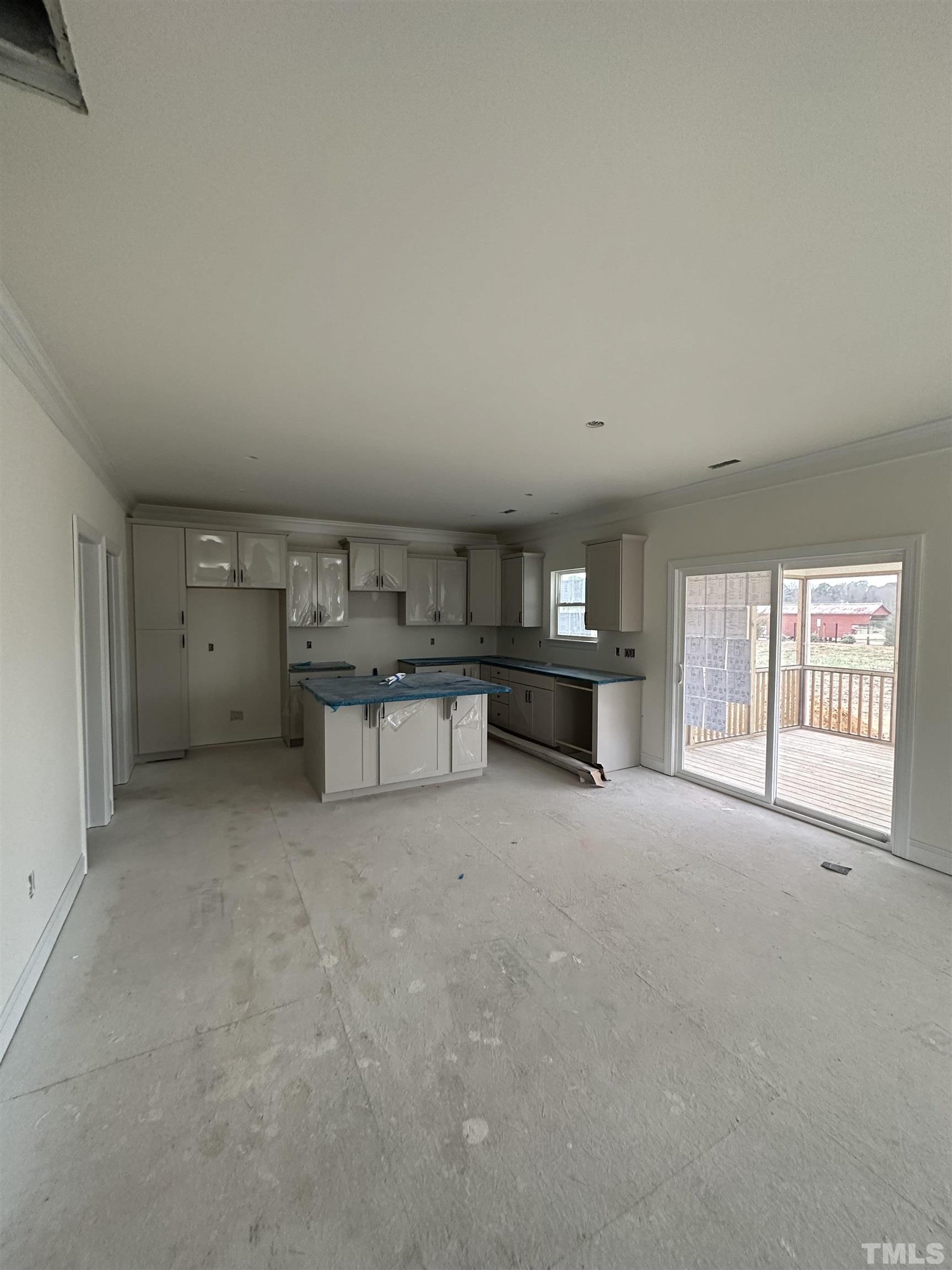 4312 Beckel Road Willow Spring, NC 27592 - Photo 6 of 23 a view of an empty room with a kitchen
