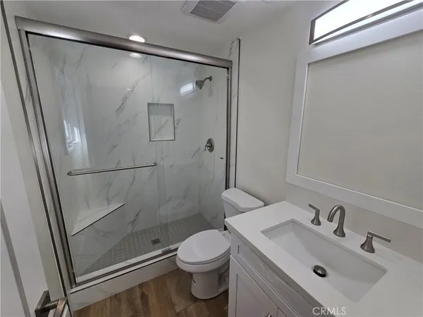 a bathroom with a sink mirror toilet and shower