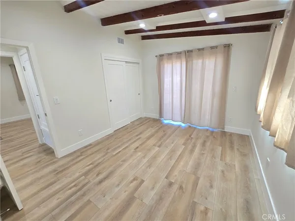 a view of a room with wooden floor and stairs