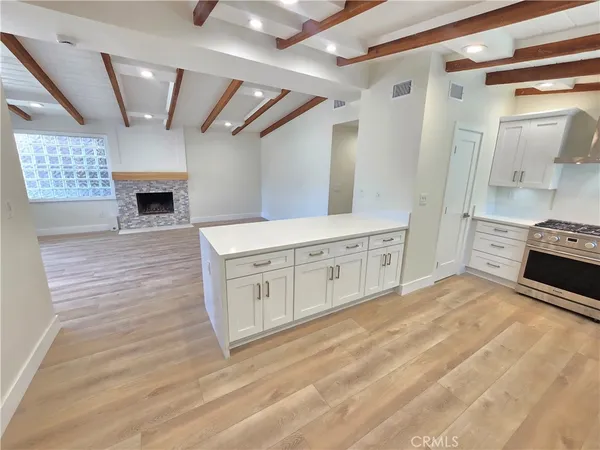 a kitchen with stainless steel appliances a stove top oven and cabinets