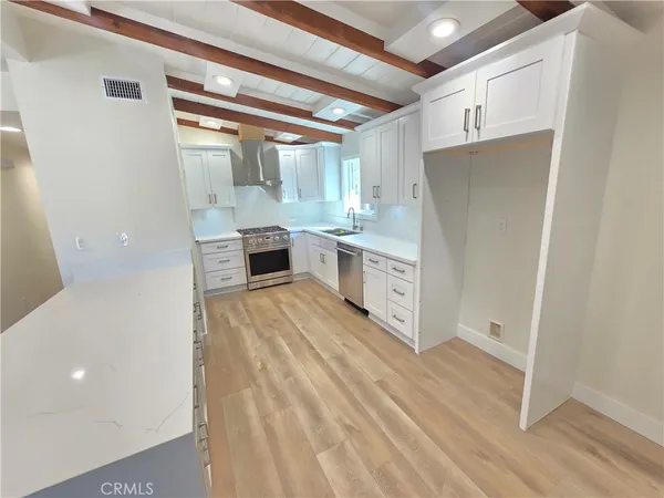 a kitchen with stainless steel appliances a refrigerator and a stove