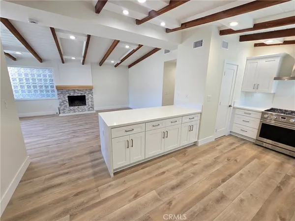 a kitchen with stainless steel appliances a stove top oven and cabinets