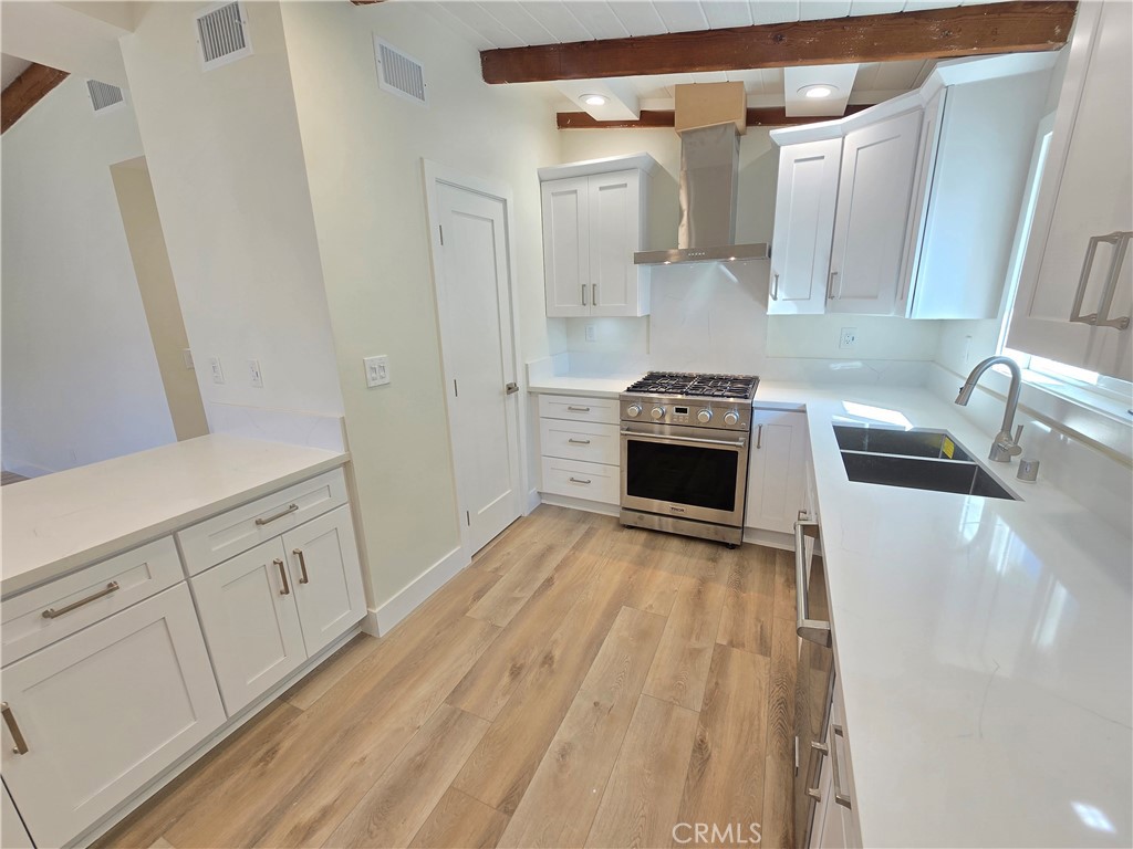 34516 Via Verde Dana Point, CA 92624 - Photo 8 of 22 a kitchen with white cabinets and white appliances