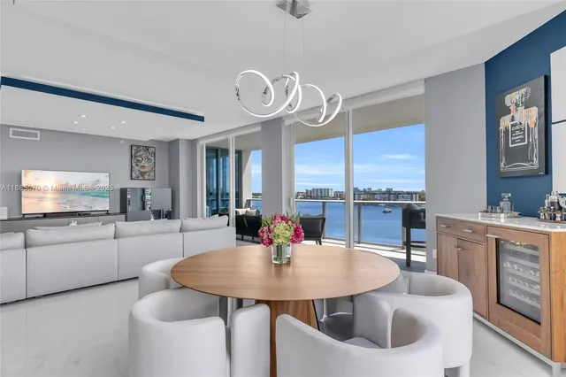 a kitchen with stainless steel appliances kitchen island granite countertop a sink and white cabinets