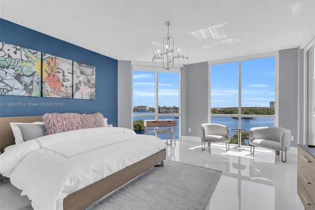 a living room with couch a dining table and a chandelier
