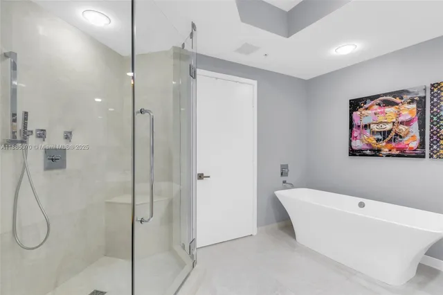 a bathroom with a tub a sink and a mirror