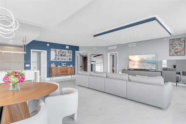 a living room with furniture kitchen and a table