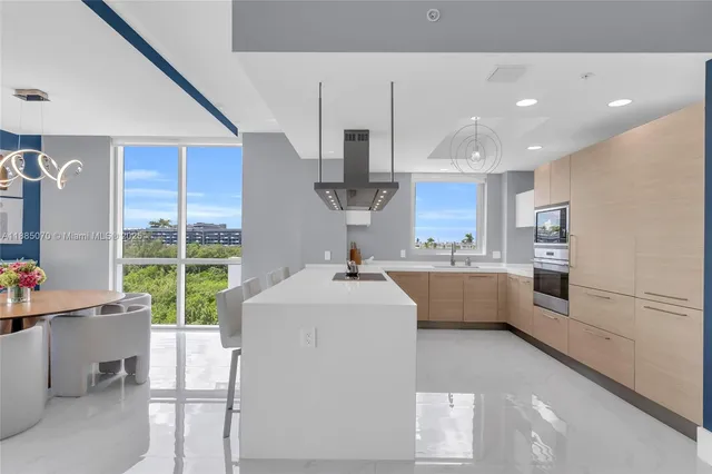 a large white kitchen with a large window