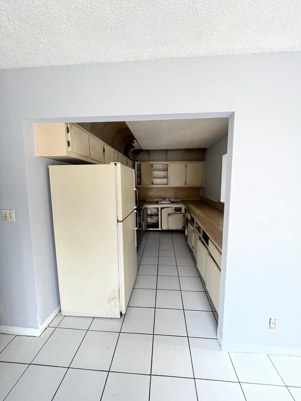 6123 Southwest 4th Place Margate, FL 33068 - Photo 6 of 12 a kitchen with a refrigerator and a stove top oven
