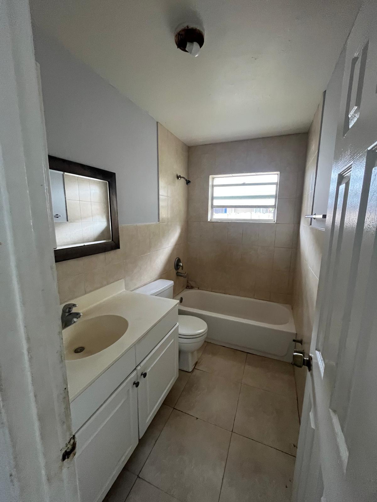 6123 Southwest 4th Place Margate, FL 33068 - Photo 8 of 12 a bathroom with a granite countertop sink toilet and shower