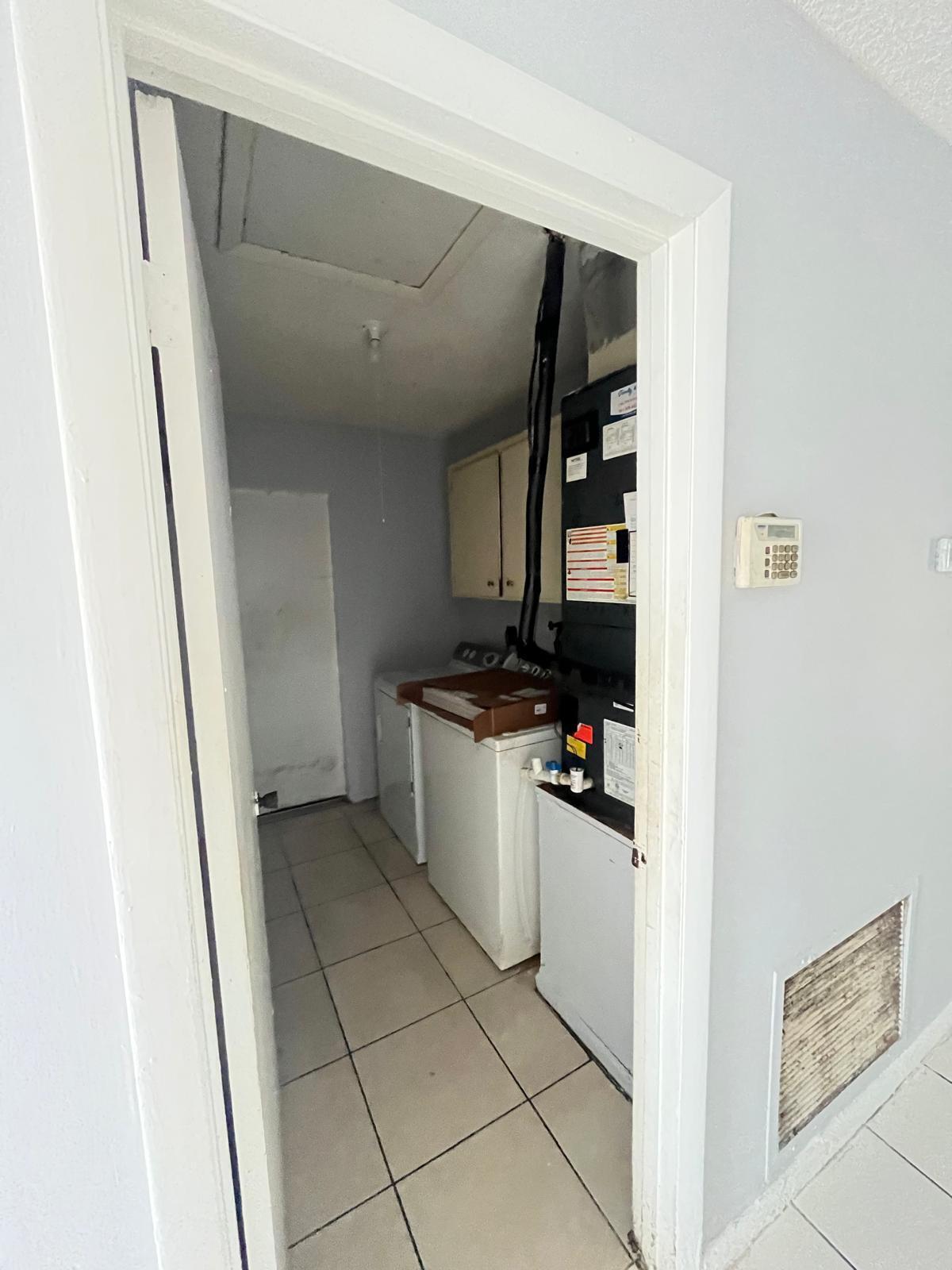 6123 Southwest 4th Place Margate, FL 33068 - Photo 9 of 12 a kitchen with a refrigerator and cabinets