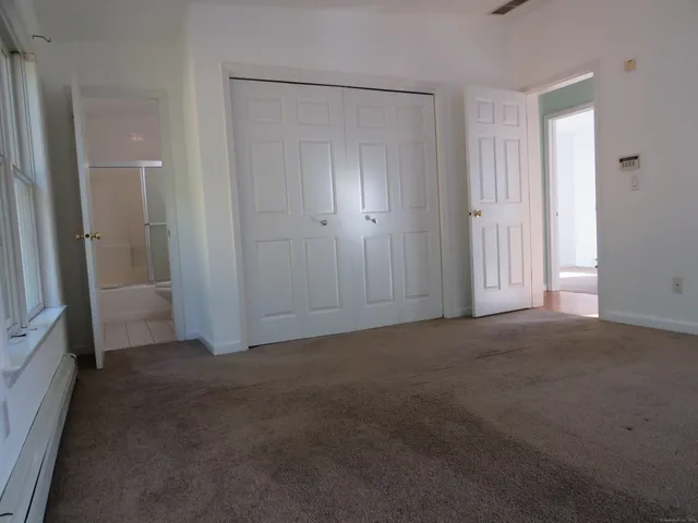 a bathroom with a granite countertop toilet and a sink