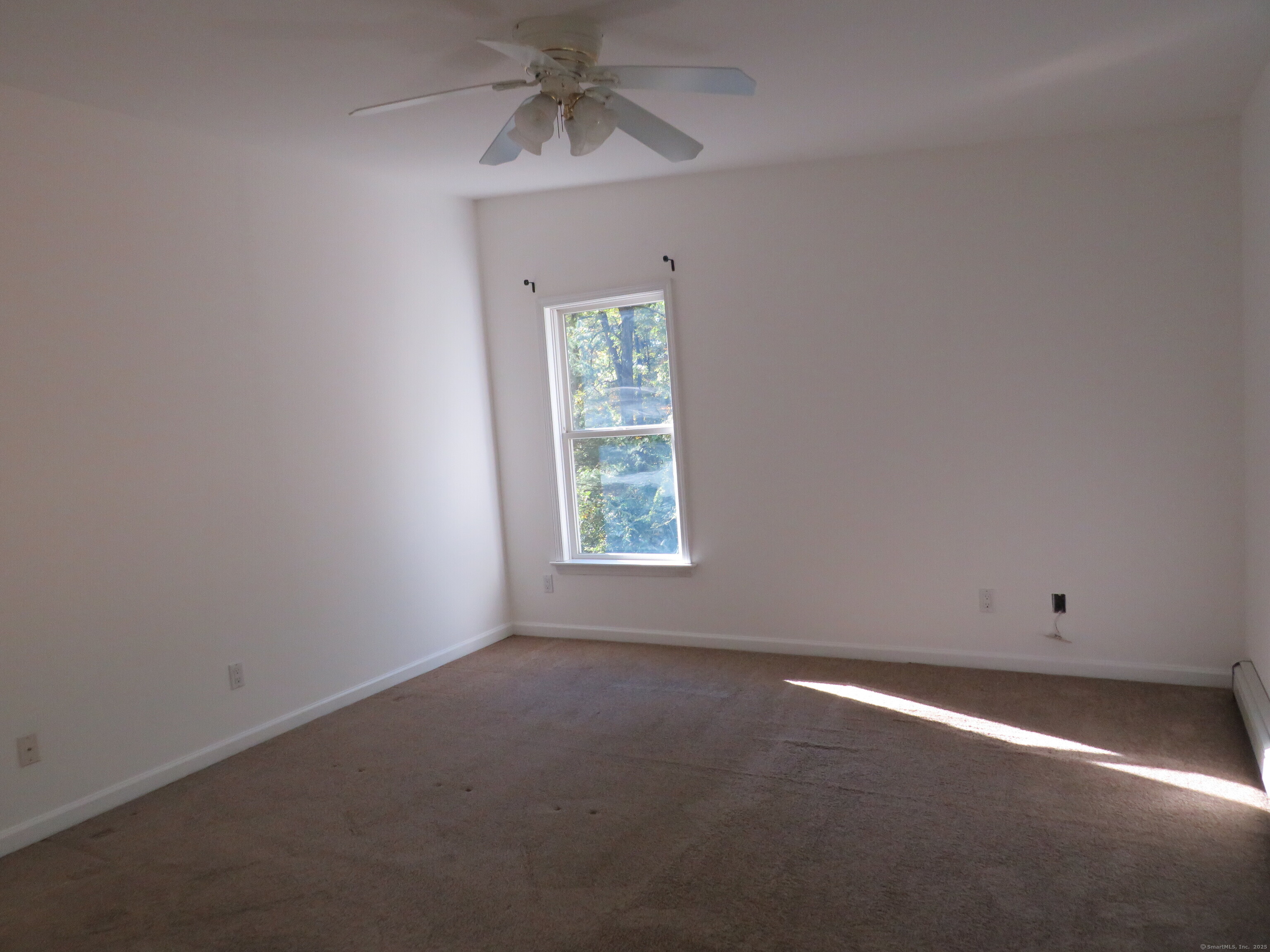 15 Hayestown Heights Danbury, CT 06811 - Photo 19 of 28 an empty room with a window and a ceiling fan