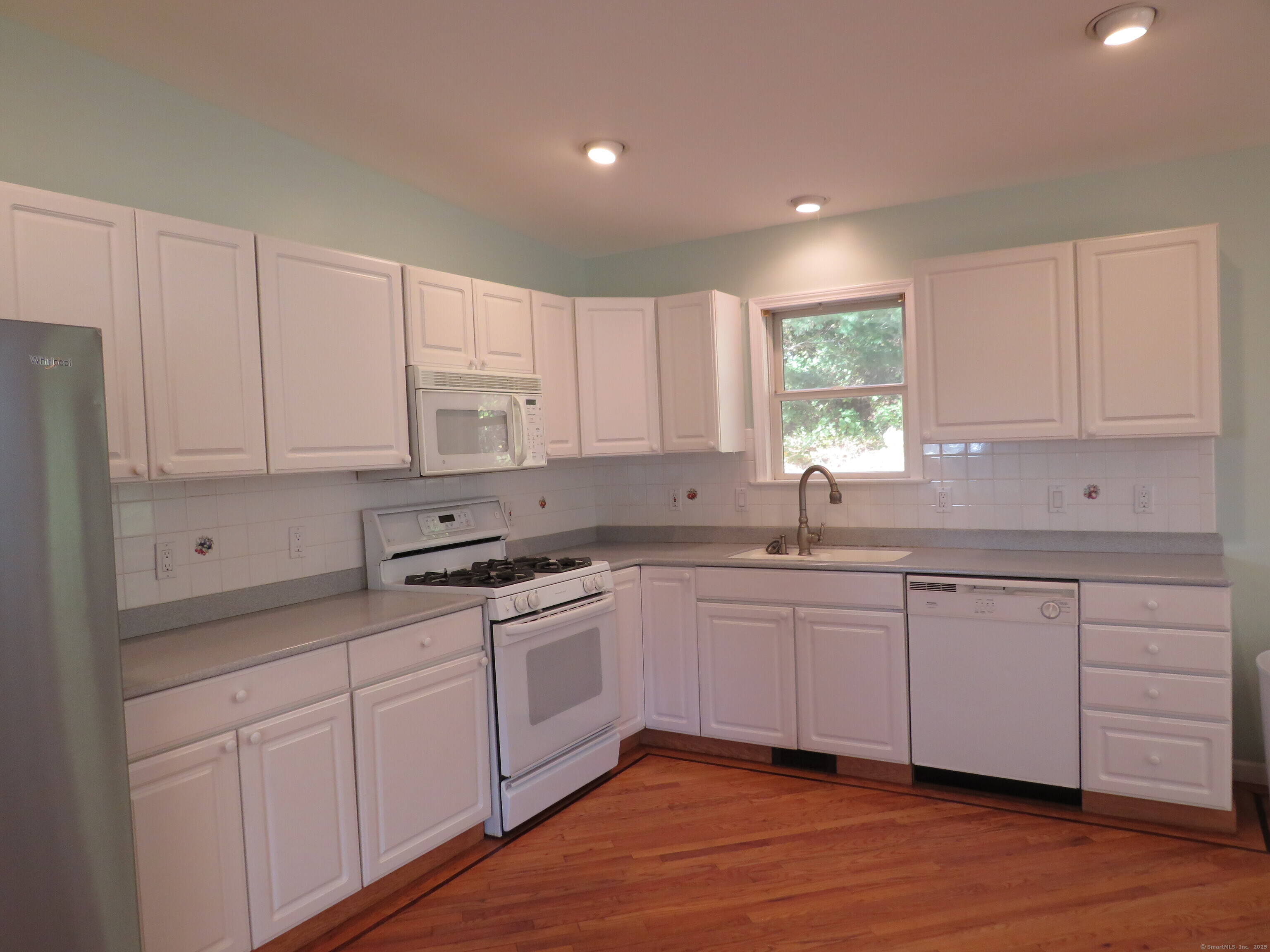 15 Hayestown Heights Danbury, CT 06811 - Photo 23 of 28 a kitchen with granite countertop white cabinets and white appliances
