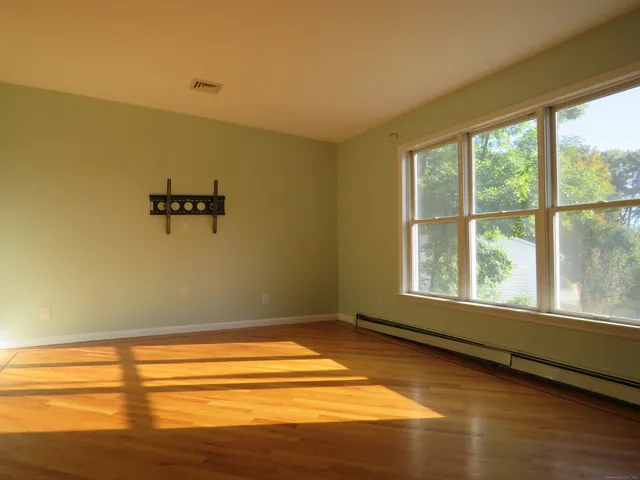 a view of a room with rack on the wall and a window