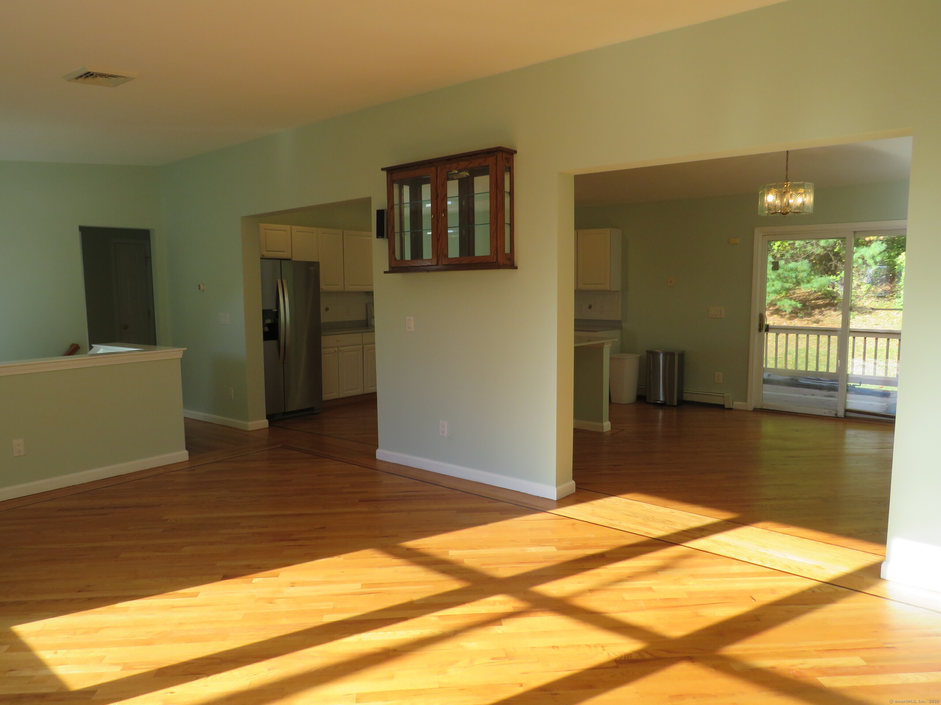 15 Hayestown Heights Danbury, CT 06811 - Photo 5 of 28 a view of a livingroom with wooden floor and a ceiling fan